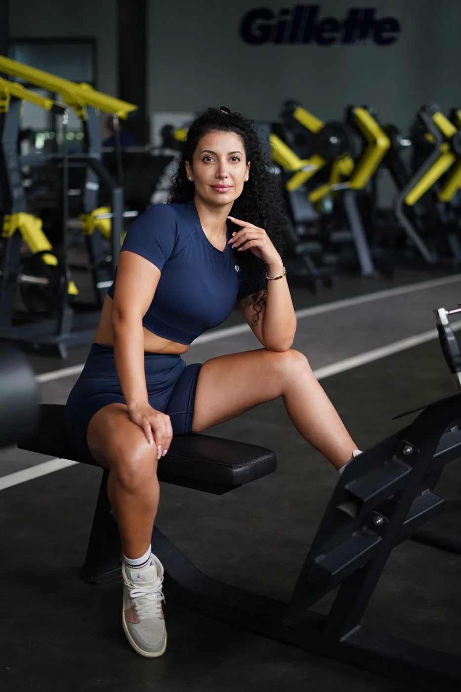 Ceece sitting on a weight bench