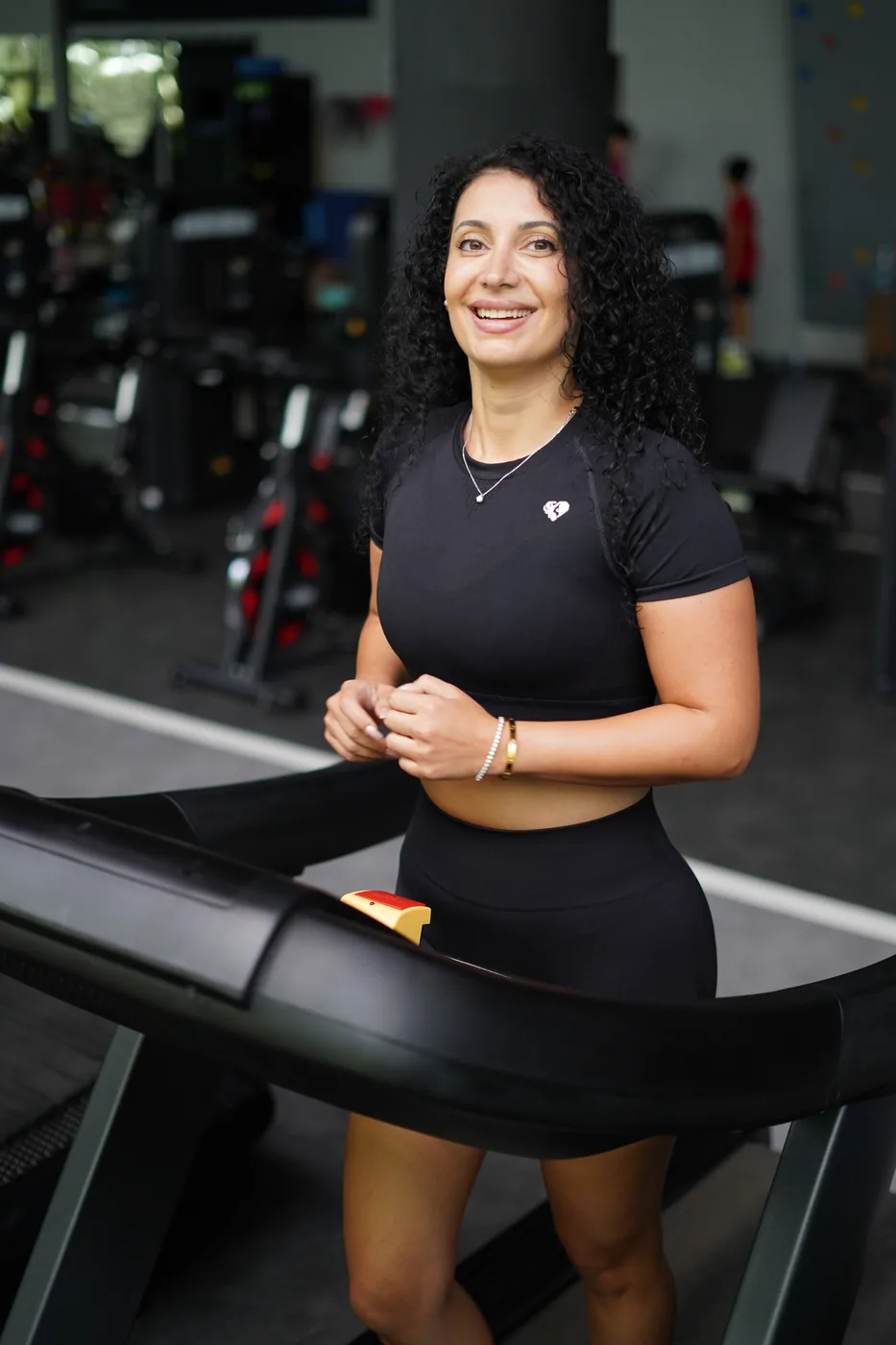 Ceece smiling on a treadmill